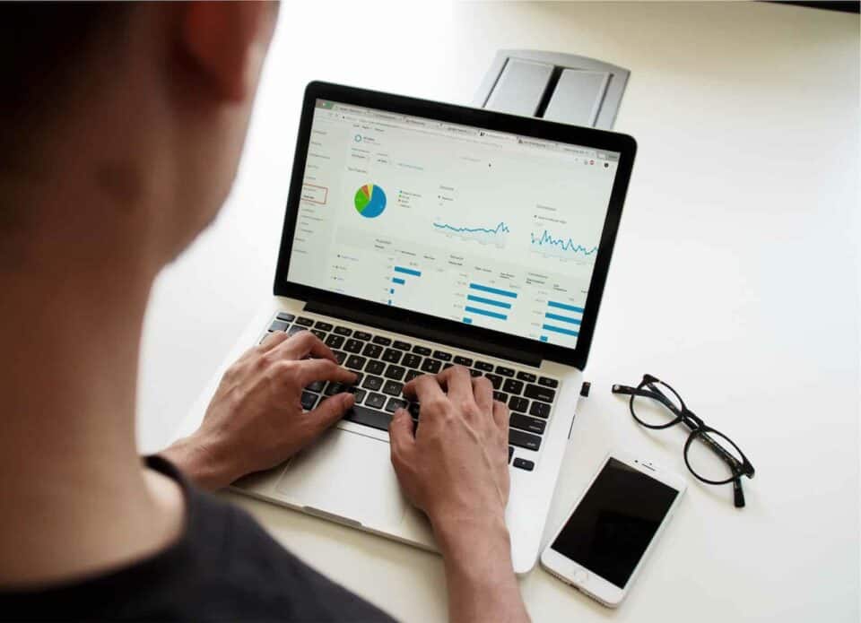 Man sitting at computer, looking at analytics